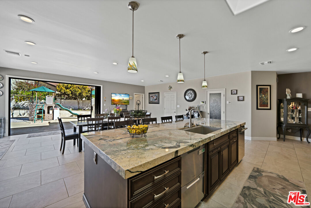 5437 Middlecrest Road Rancho Palos Verdes, CA 90275 - Photo 6 of 32 a kitchen with stainless steel appliances granite countertop a stove and a center island