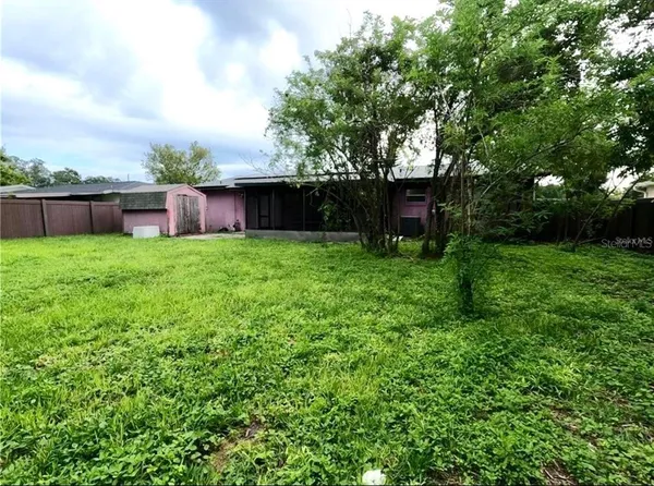 a view of a house with a backyard