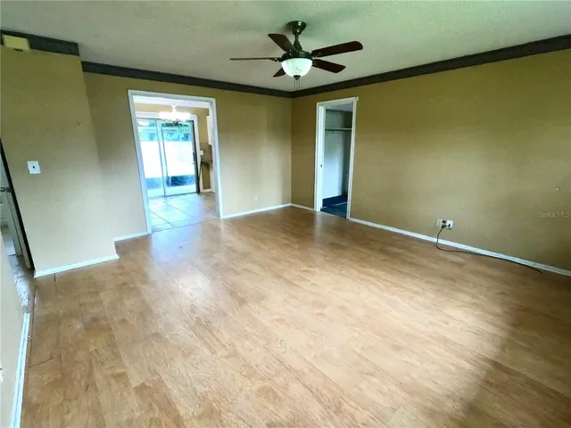 a view of empty room with ceiling fan