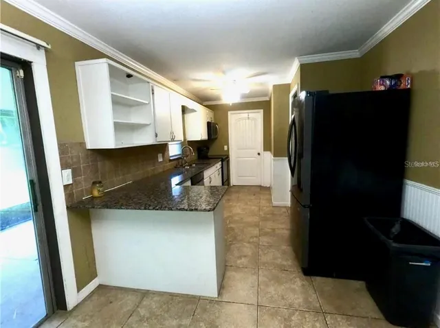 a kitchen with a refrigerator and a sink