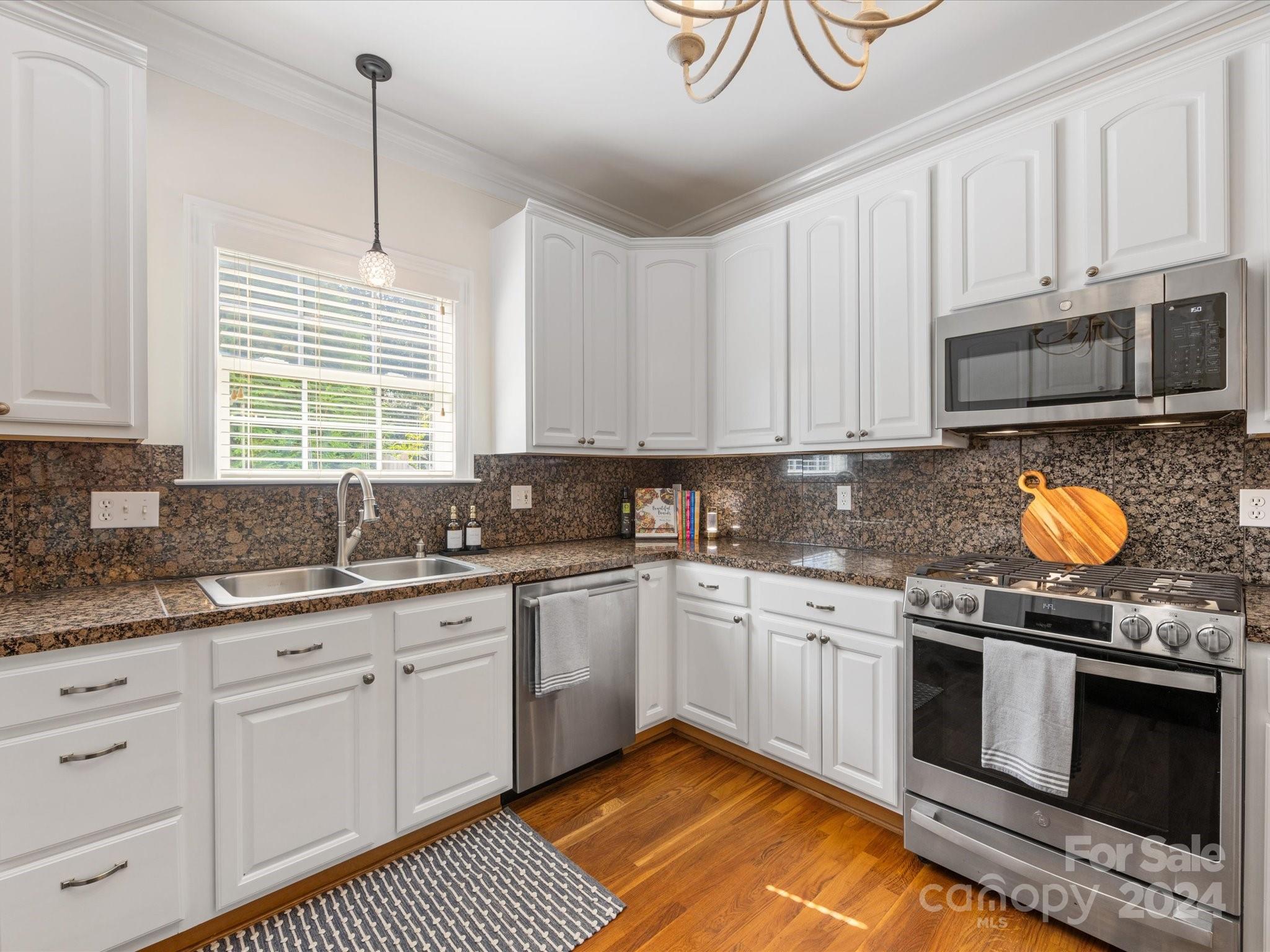 4100 Cherrybrook Drive Mint Hill, NC 28227 - Photo 13 of 45 a kitchen with stainless steel appliances granite countertop a stove sink and cabinets