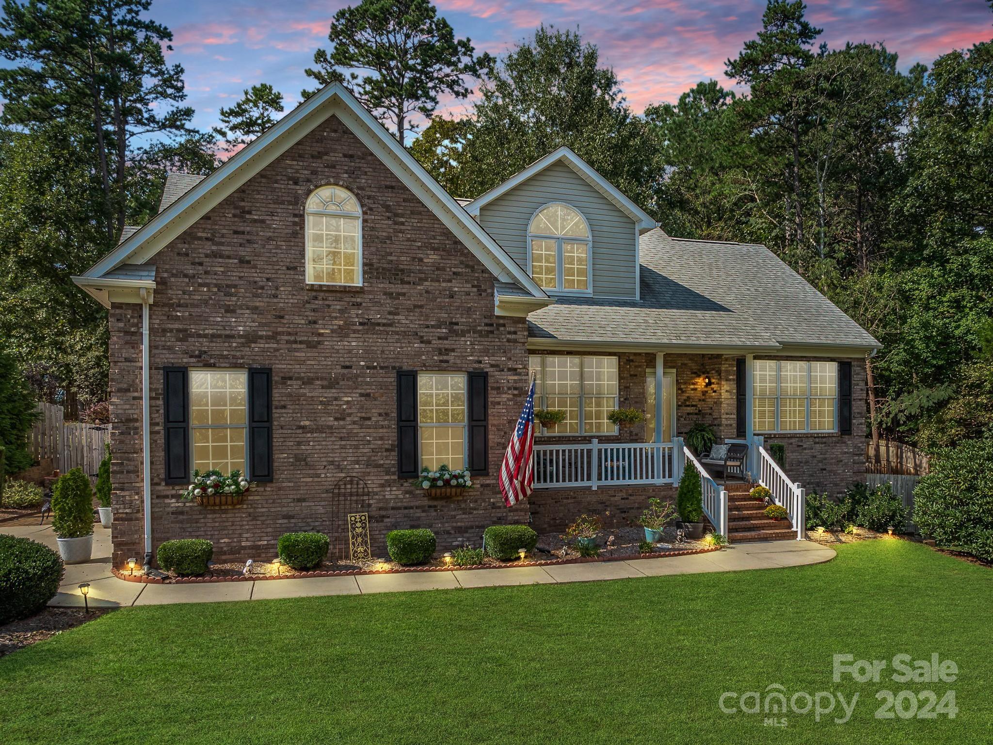 4100 Cherrybrook Drive Mint Hill, NC 28227 - Photo 2 of 45 a front view of a house with a yard and trees