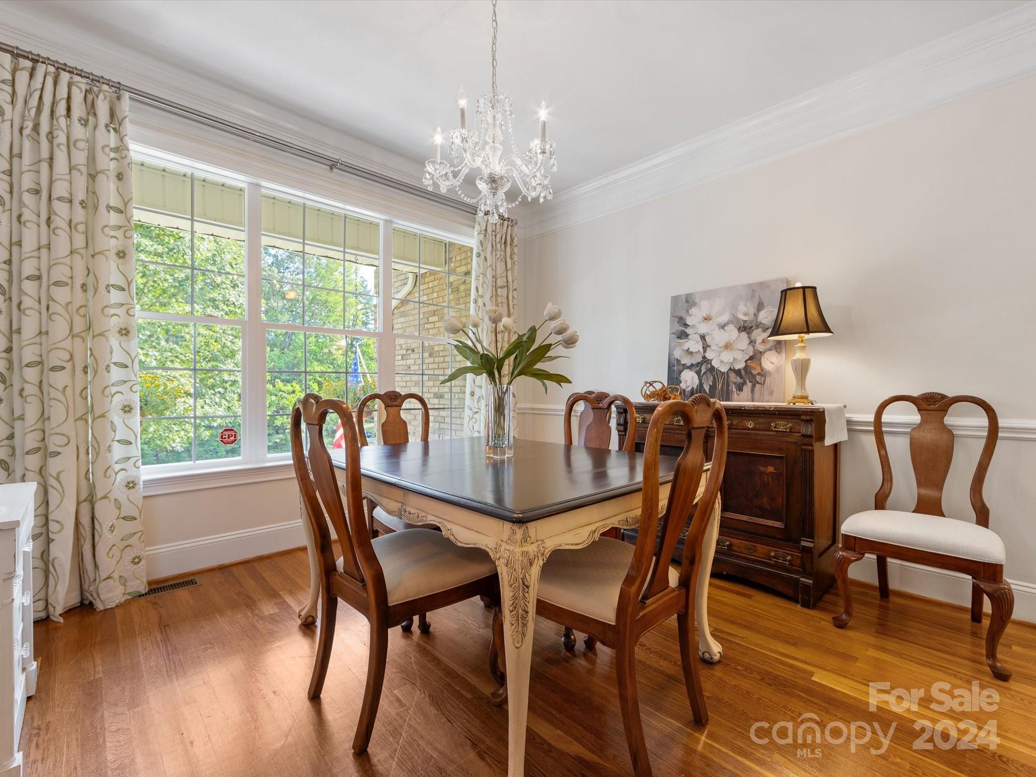 4100 Cherrybrook Drive Mint Hill, NC 28227 - Photo 8 of 45 a dining room with furniture a large window and wooden floor