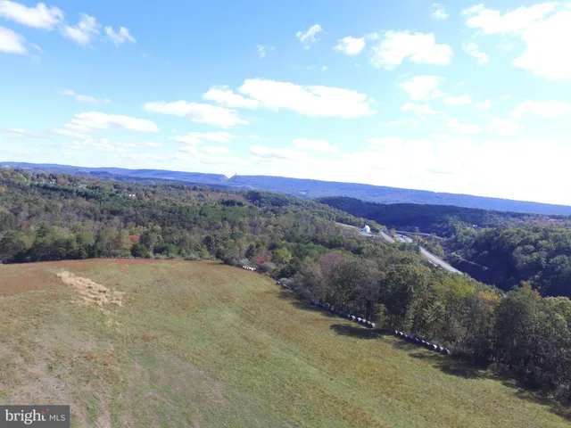 a view of a road with mountains in the background