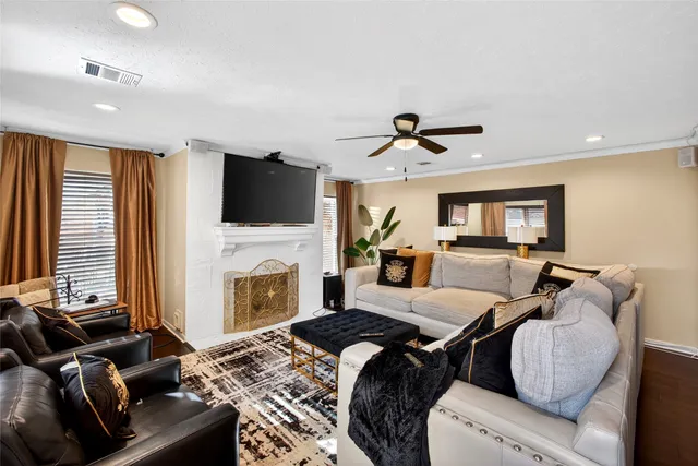a living room with furniture fireplace and flat screen tv