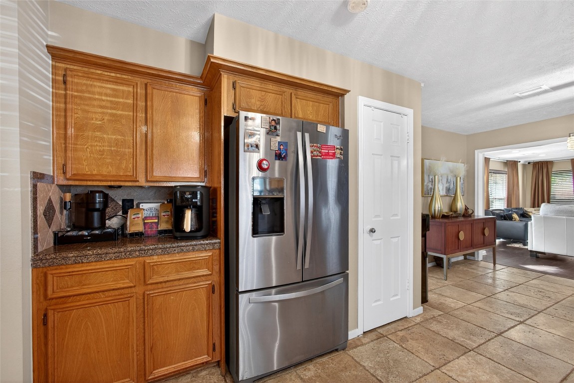 19115 Keyturn Lane Humble, TX 77346 - Photo 13 of 32 a kitchen with stainless steel appliances granite countertop a refrigerator and a stove top oven
