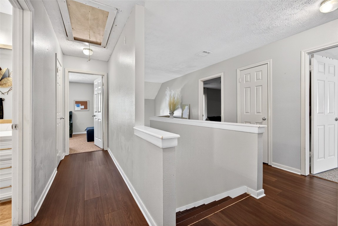 19115 Keyturn Lane Humble, TX 77346 - Photo 16 of 32 a view of a hallway with wooden floor and staircase