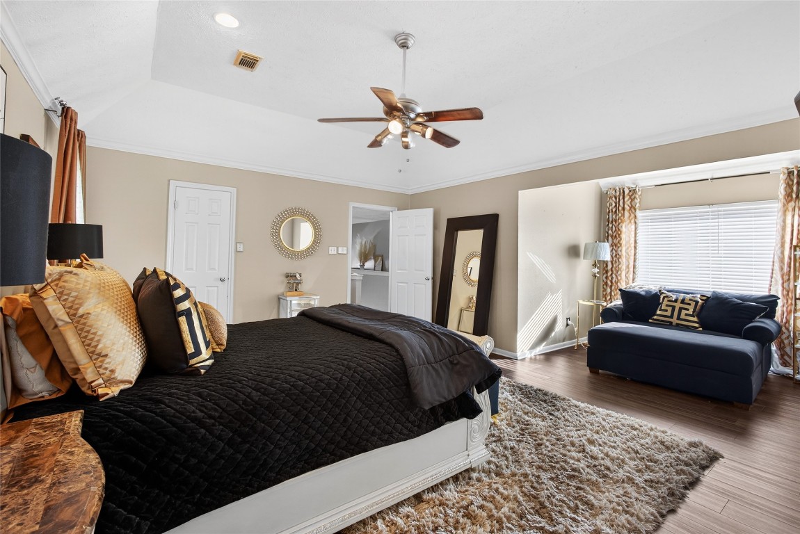 19115 Keyturn Lane Humble, TX 77346 - Photo 2 of 32 a bedroom with a bed lamp and a dresser