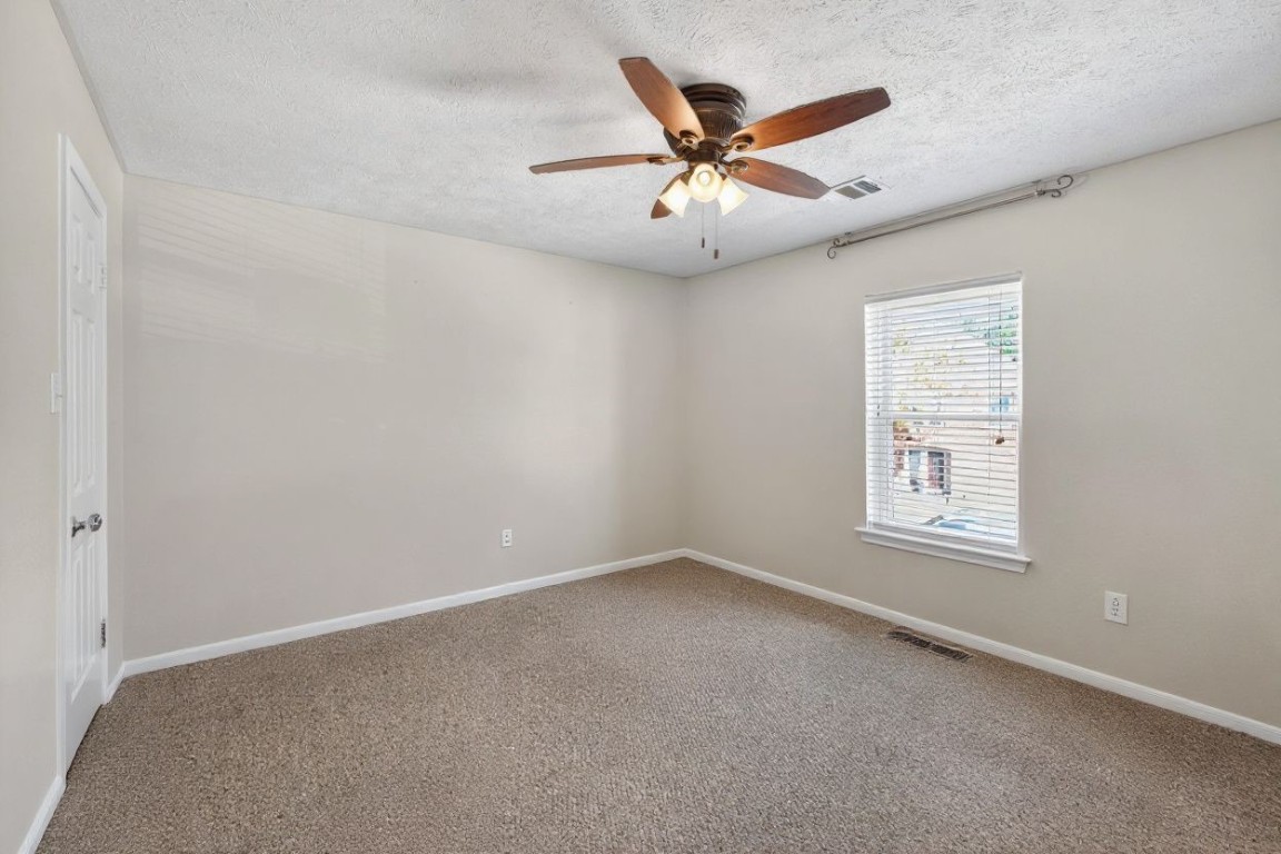 19115 Keyturn Lane Humble, TX 77346 - Photo 21 of 32 an empty room with windows and fan