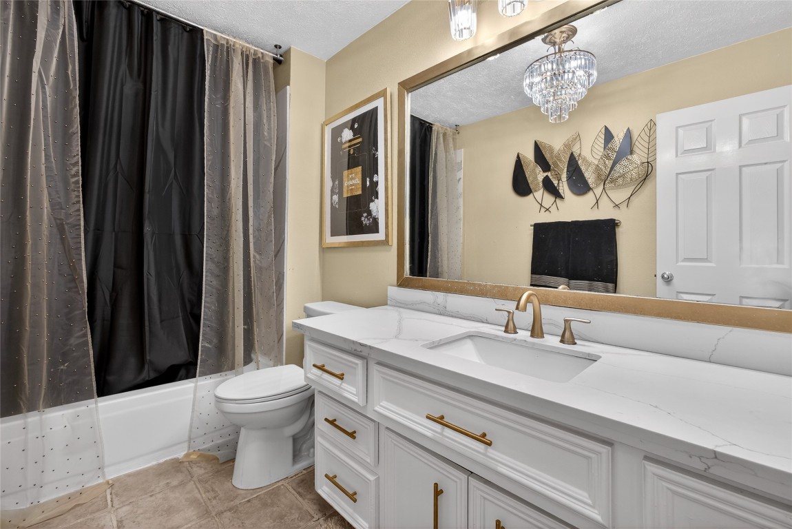 19115 Keyturn Lane Humble, TX 77346 - Photo 22 of 32 a bathroom with a sink a toilet and mirror