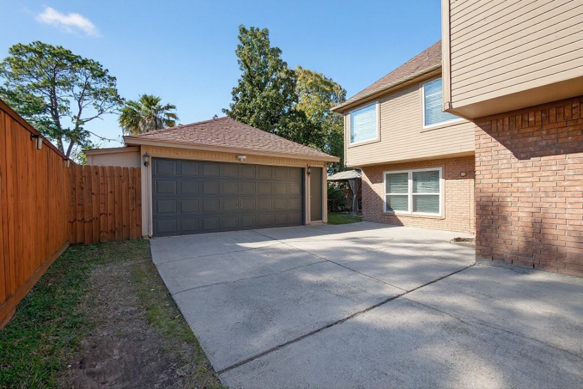 19115 Keyturn Lane Humble, TX 77346 - Photo 27 of 32 a front view of a house with a yard and garage