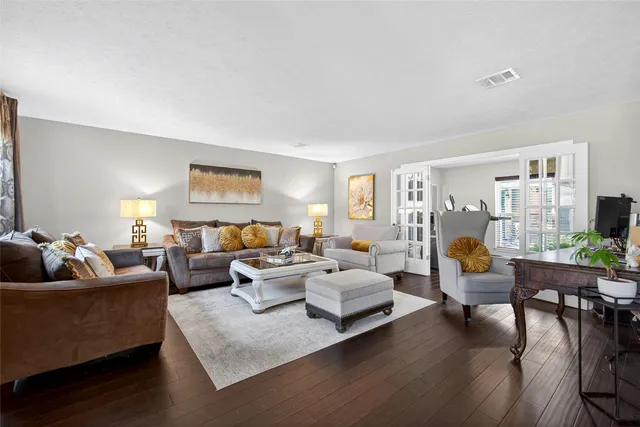 a living room with furniture and wooden floor