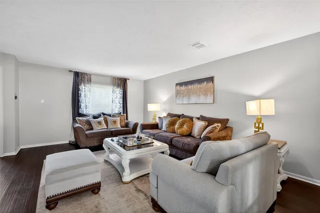 a living room with furniture and a lamp