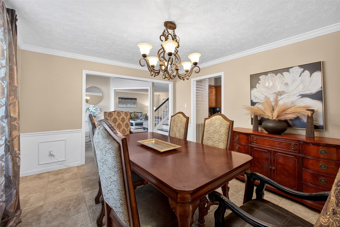 19115 Keyturn Lane Humble, TX 77346 - Photo 9 of 32 a view of a dining room with furniture and chandelier