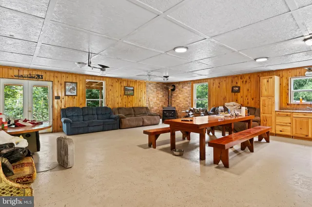 a living room with furniture a large pool table and a fireplace