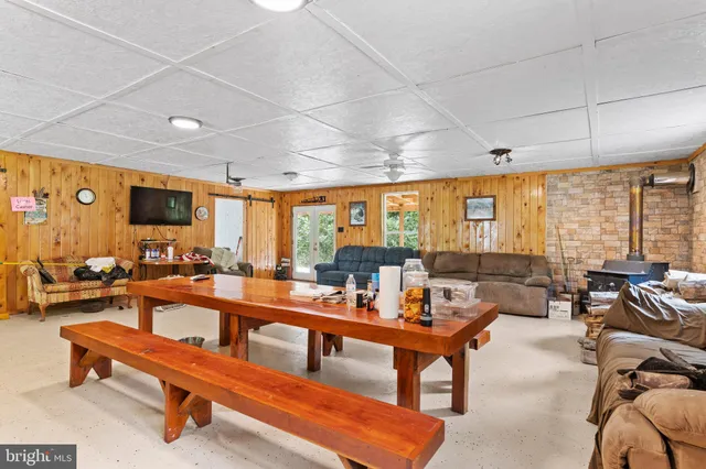 a living room with furniture a flat screen tv and a large window