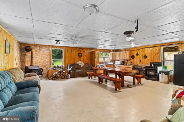 a living room with lots of furniture and a large window