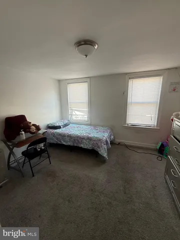 a bedroom with bed and a window