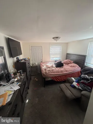 a bedroom with a bed and a chair