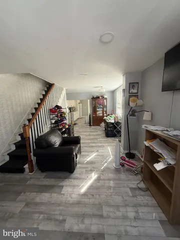 a living room with furniture and a gym machine