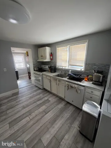 a kitchen with wooden floors and a stove