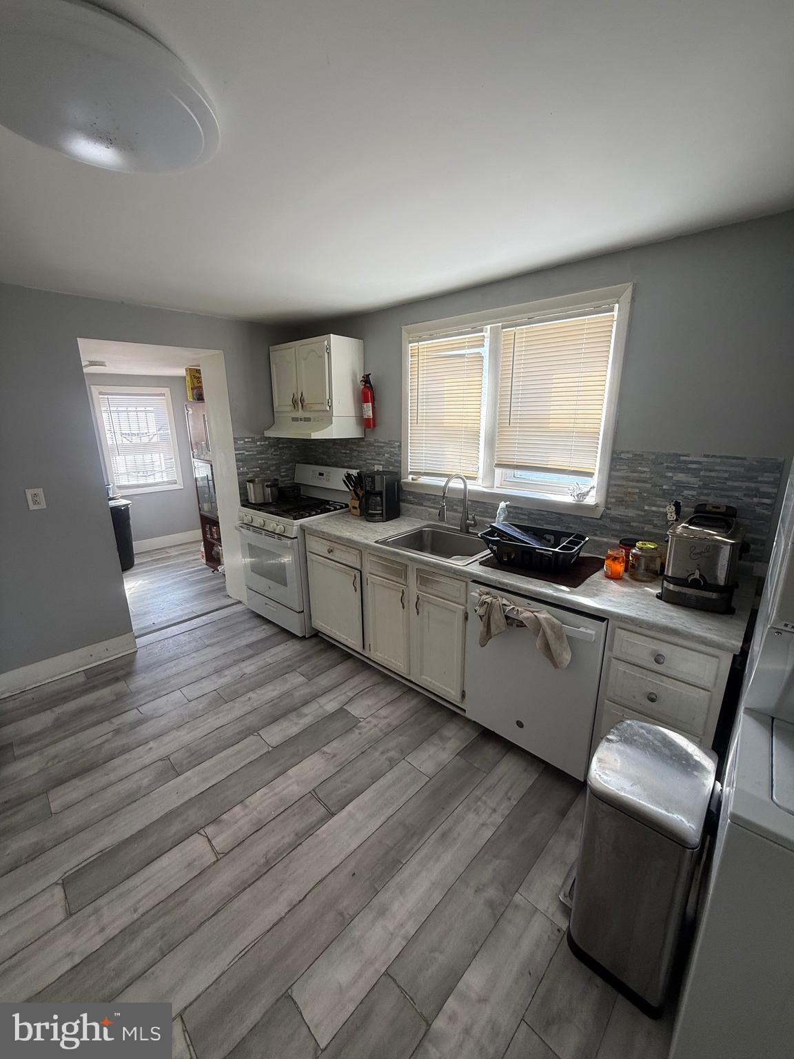 619 West 5th Street Chester, PA 19013 - Photo 6 of 17 a kitchen with wooden floors and a stove
