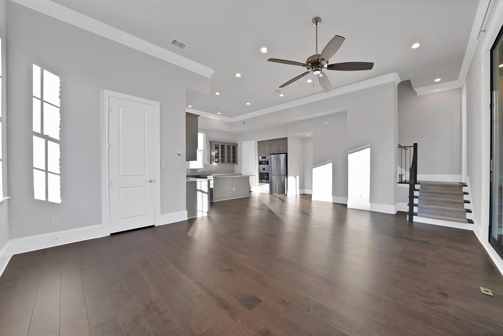 5437 Patterson Street Irving, TX 75039 - Photo 12 of 40 one of the largest main living spaces in the community, crown molding, recessed lighting, and dark wood-style floors