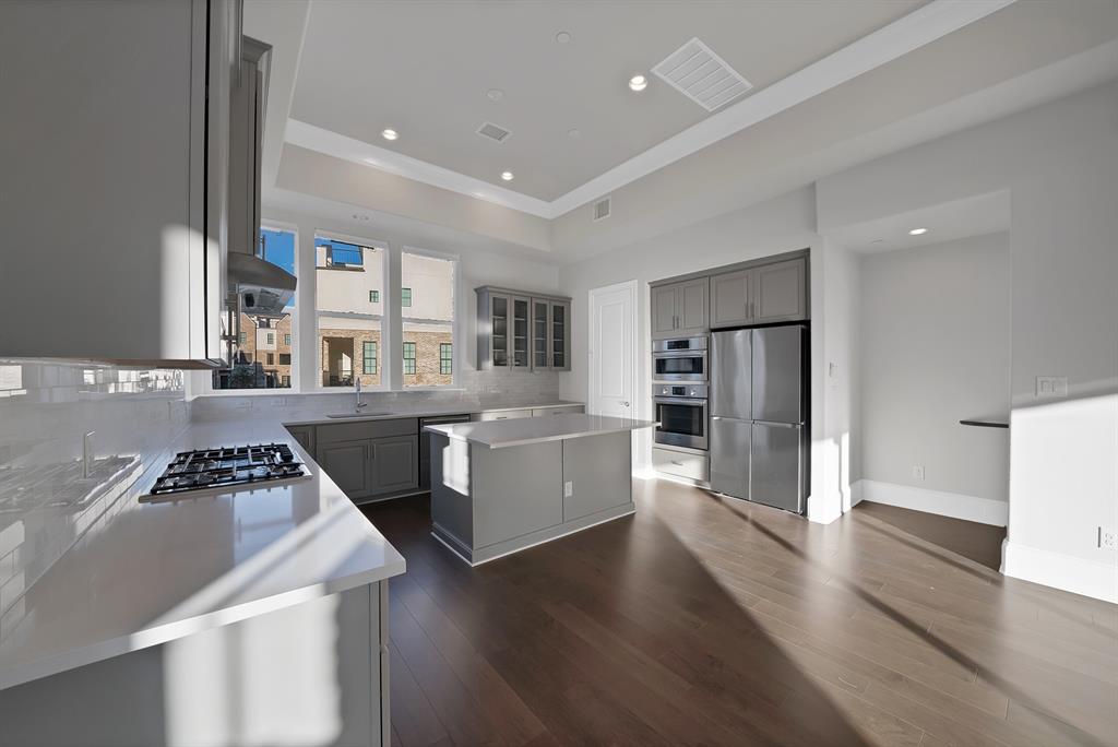 5437 Patterson Street Irving, TX 75039 - Photo 14 of 40 Kitchen featuring a kitchen island, gray cabinets, stainless steel appliances, dark wood-style floors, and recessed lighting