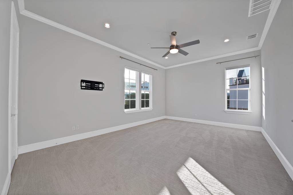 5437 Patterson Street Irving, TX 75039 - Photo 26 of 40 Primary bedroom on level 3, featuring light colored carpet, crown molding, a ceiling fan, and recessed lighting