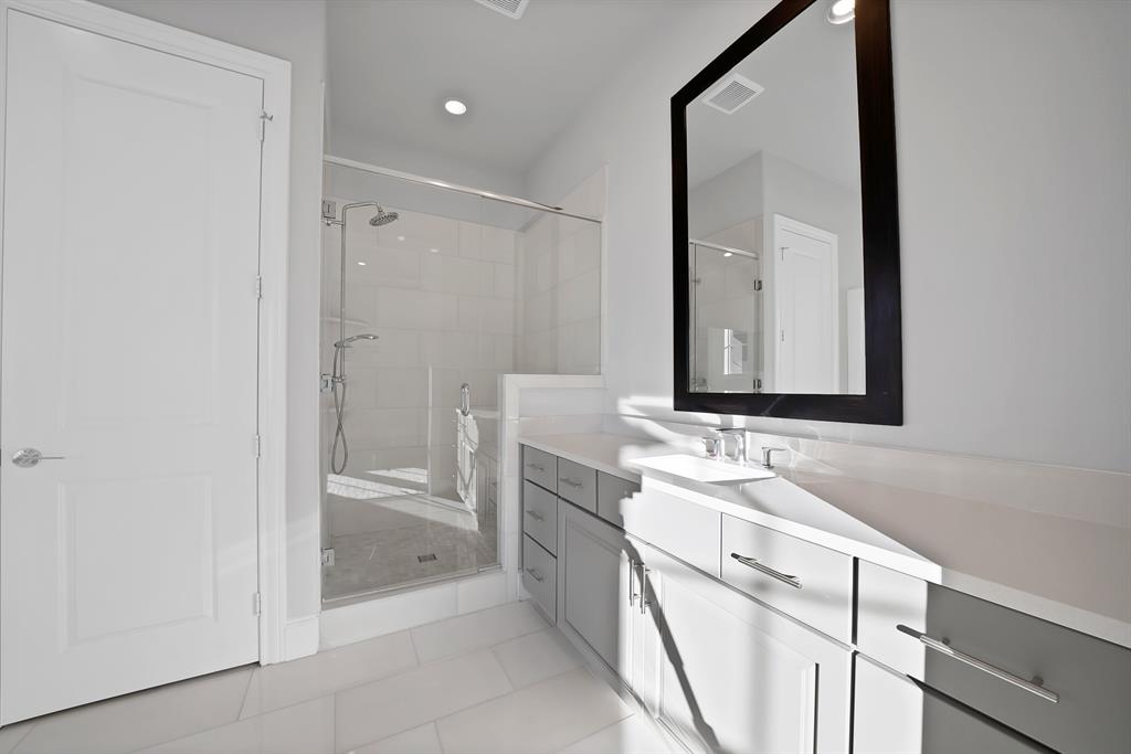 5437 Patterson Street Irving, TX 75039 - Photo 28 of 40 Primary bathroom with vanity, light tile patterned floors, a shower stall, and recessed lighting