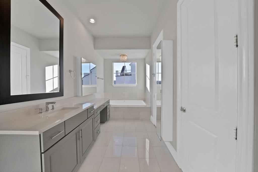 5437 Patterson Street Irving, TX 75039 - Photo 29 of 40 Primary bathroom (view 2) with vanity, a bath, and light tile patterned floors