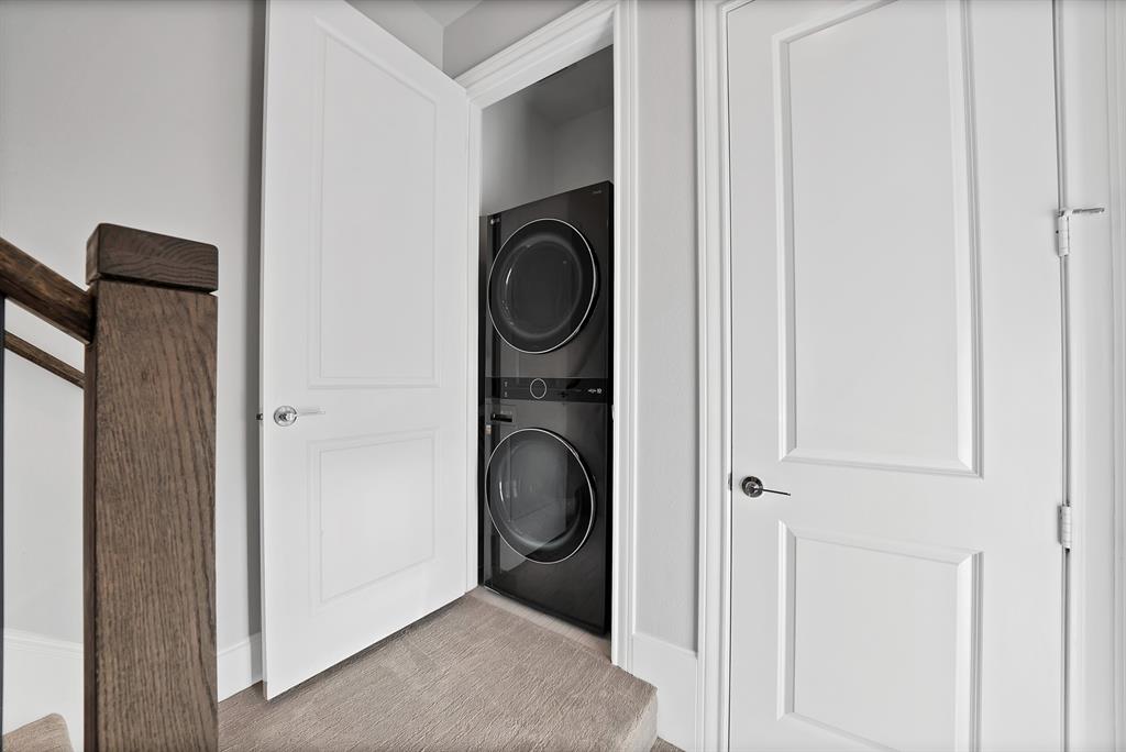 5437 Patterson Street Irving, TX 75039 - Photo 31 of 40 Laundry area featuring stacked washer and dryer that are included in the sale