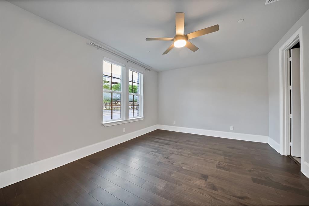 5437 Patterson Street Irving, TX 75039 - Photo 32 of 40 1st floor 2nd Primary room with on-suite bathroom featuring wood-style flooring and a ceiling fan