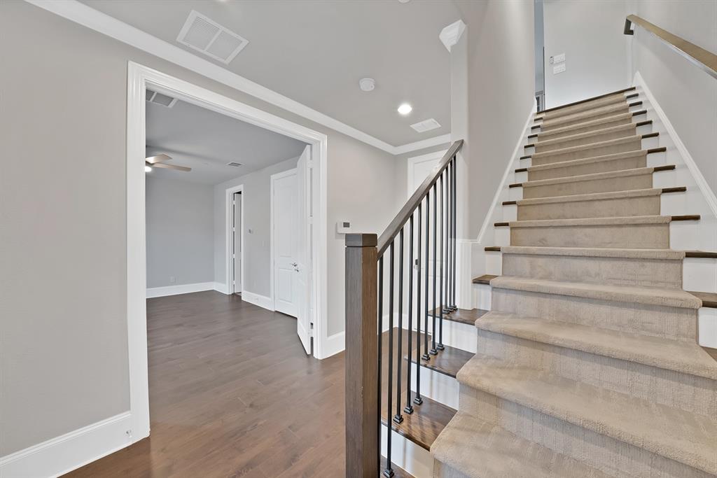 5437 Patterson Street Irving, TX 75039 - Photo 35 of 40 Entryway w/ 1st floor 2nd primary bedroom, Stairway featuring wood finished floors, ceiling fan, and recessed lighting