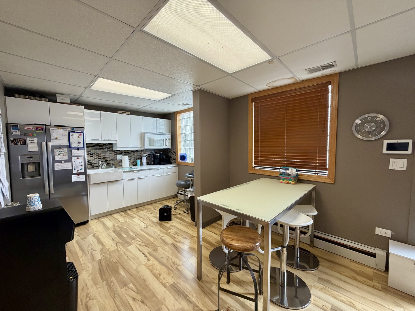 134 West State Street Sycamore, IL 60178 - Photo 15 of 20 a kitchen with stainless steel appliances kitchen island granite countertop a refrigerator a stove a sink dishwasher with a dining table and chairs