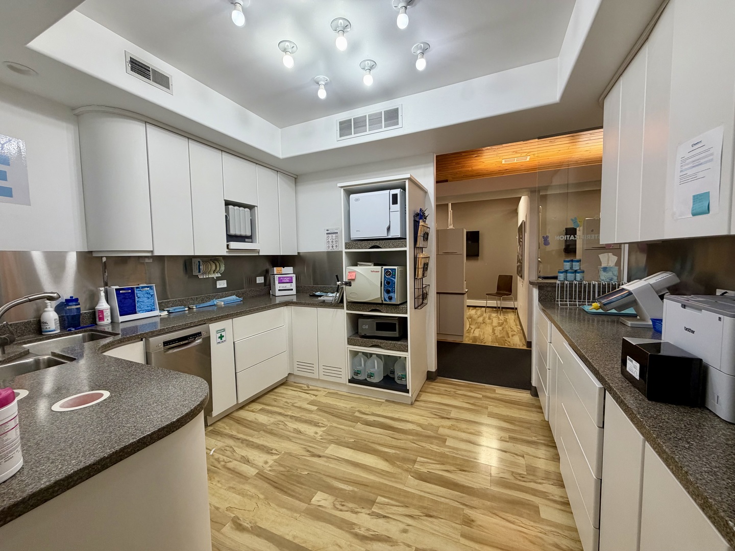 134 West State Street Sycamore, IL 60178 - Photo 19 of 20 a kitchen with stainless steel appliances granite countertop a refrigerator a sink dishwasher a stove and white cabinets with wooden floor