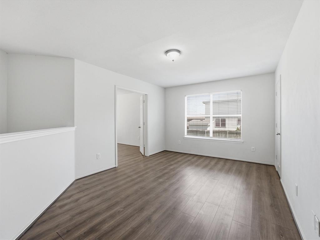 2021 Laughlin Road Fort Worth, TX 76177 - Photo 19 of 40 an empty room with wooden floor and windows
