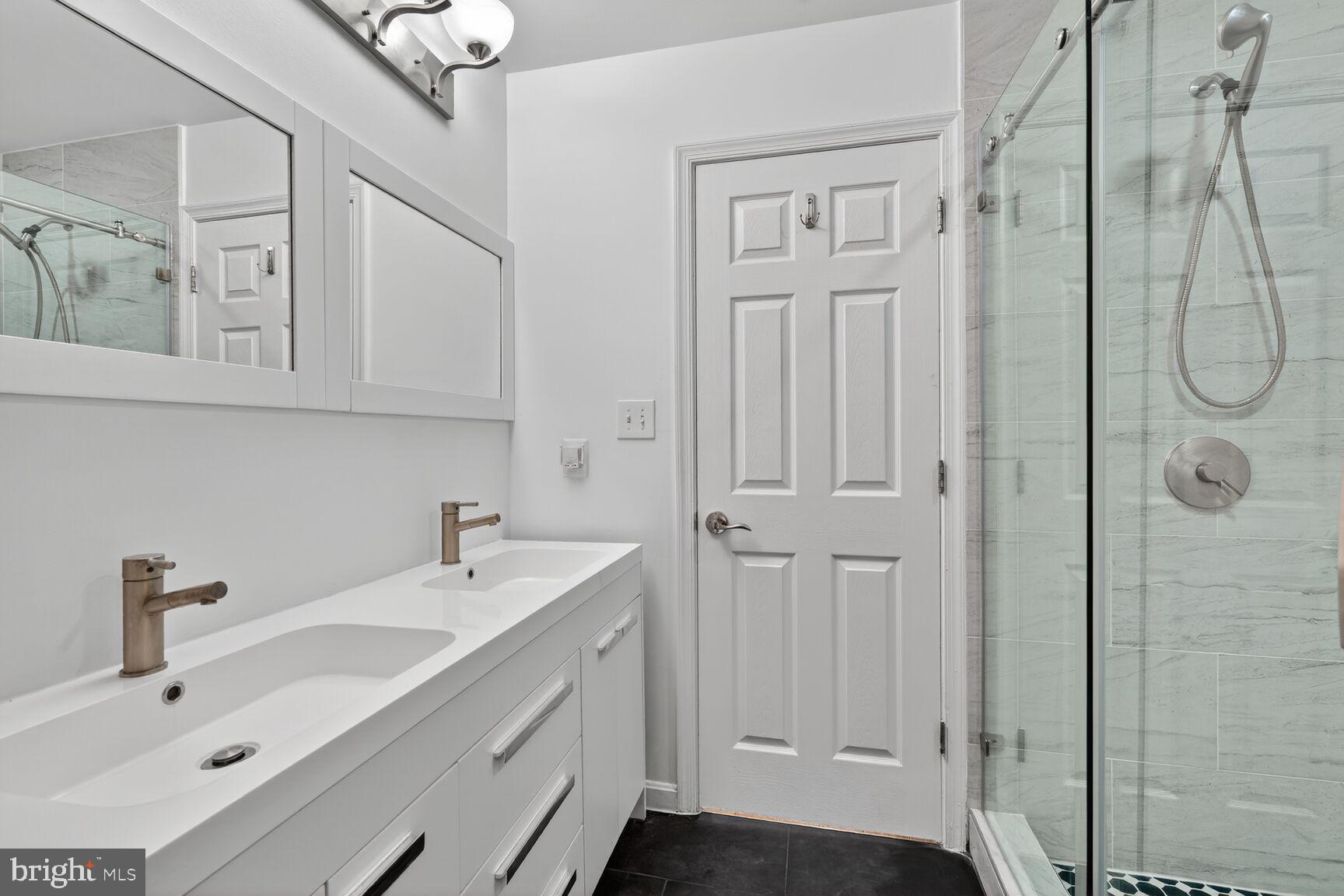 1242 Anacostia Road Southeast Washington, DC 20019 - Photo 13 of 27 a bathroom with a sink a mirror and shower