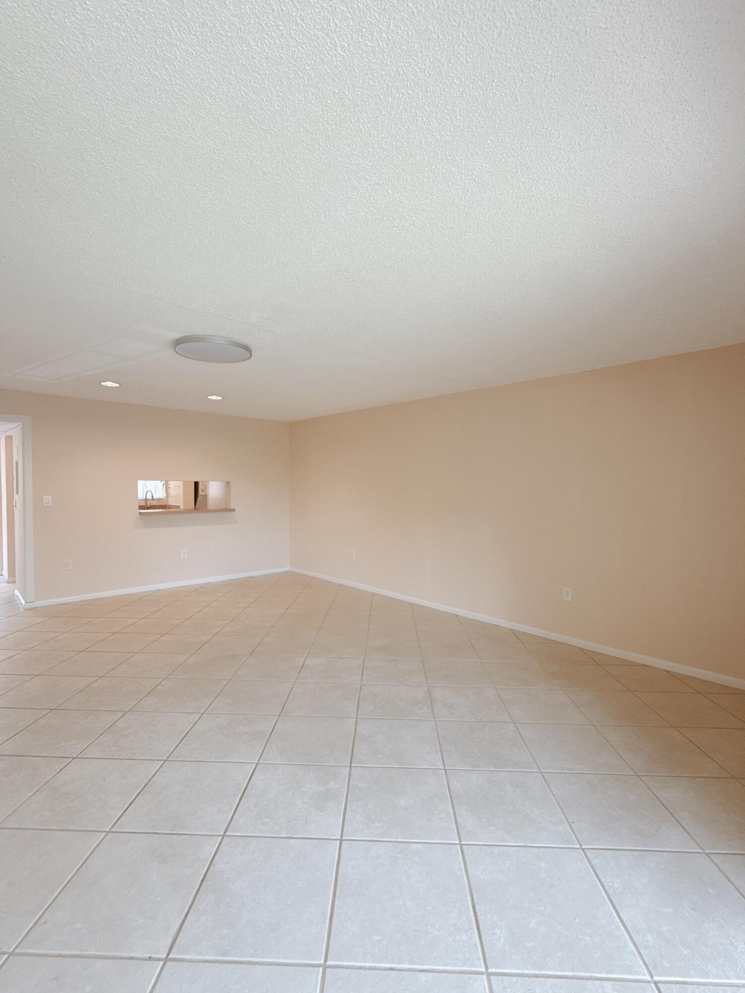 872 Southwest 9th St Circle, Unit 201 Boca Raton, FL 33486 - Photo 8 of 14 Living room facing the kitchen