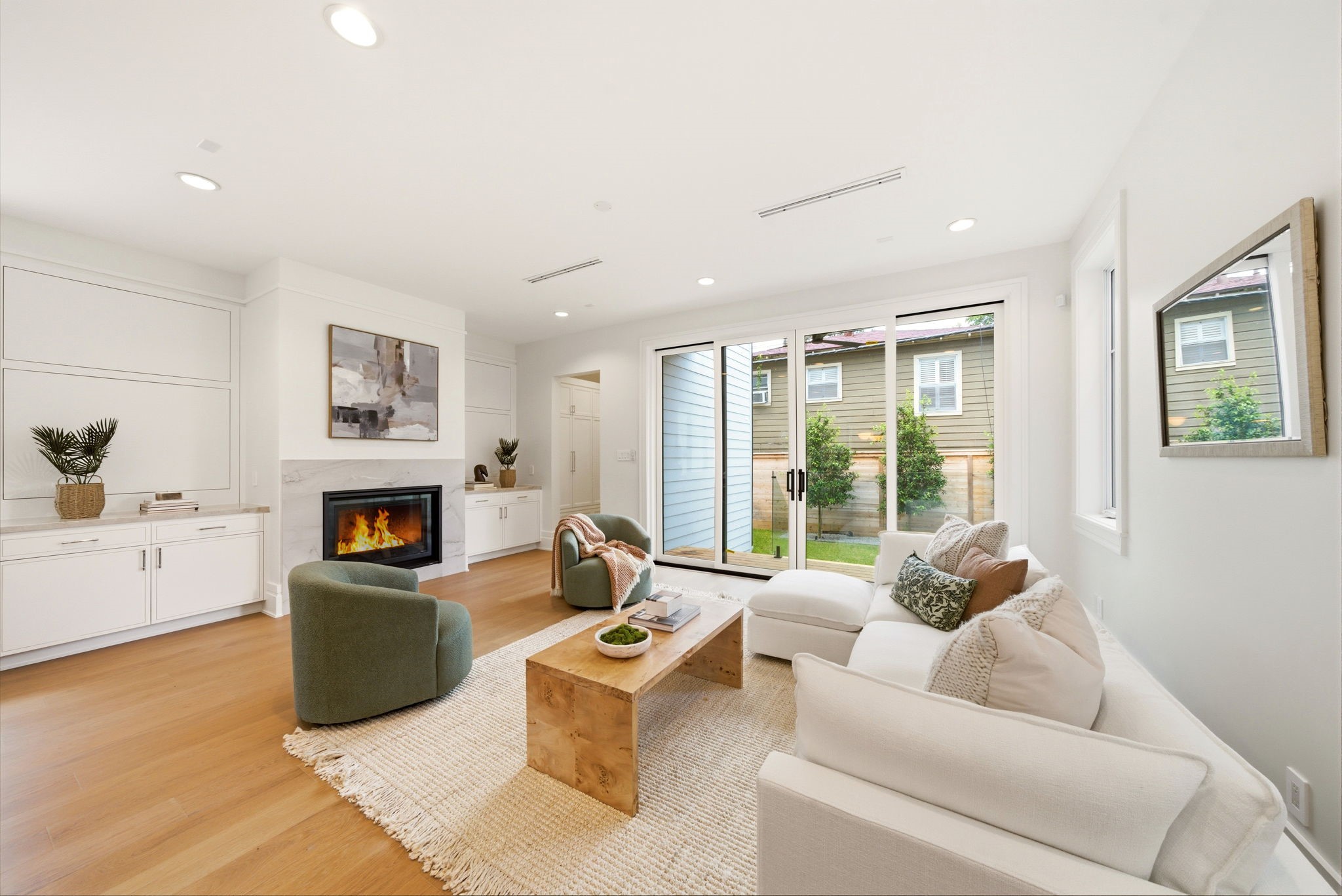 1023 Euclid Street Houston, TX 77009 - Photo 18 of 50 Bright and inviting family room featuring custom built-ins, contemporary fireplace, and seamless indoor-outdoor flow.