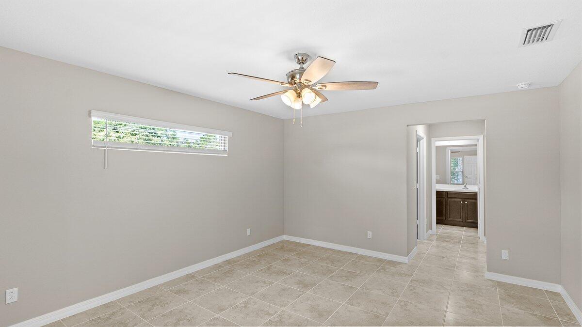 1213 Ragen Road Southeast Palm Bay, FL 32909 - Photo 15 of 26 an empty room with windows and fan