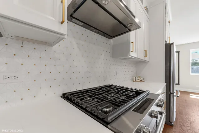 a stove top oven sitting inside of a kitchen