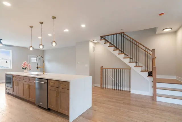 a view of a kitchen with a sink and cabinets