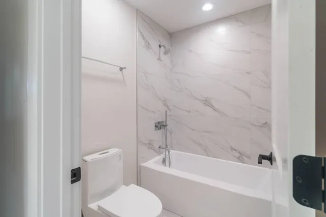 a bathroom with a toilet and a bathtub