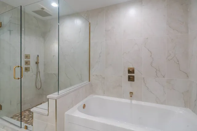 a bathroom with a bathtub and shower