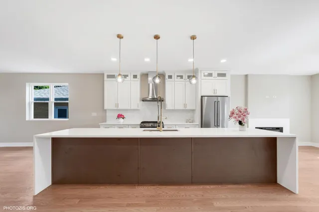a kitchen with kitchen island sink stove and cabinets