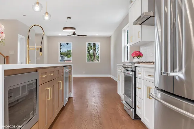 a kitchen with stainless steel appliances a stove top oven and a refrigerator