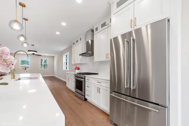 a kitchen with stainless steel appliances a refrigerator sink and stove