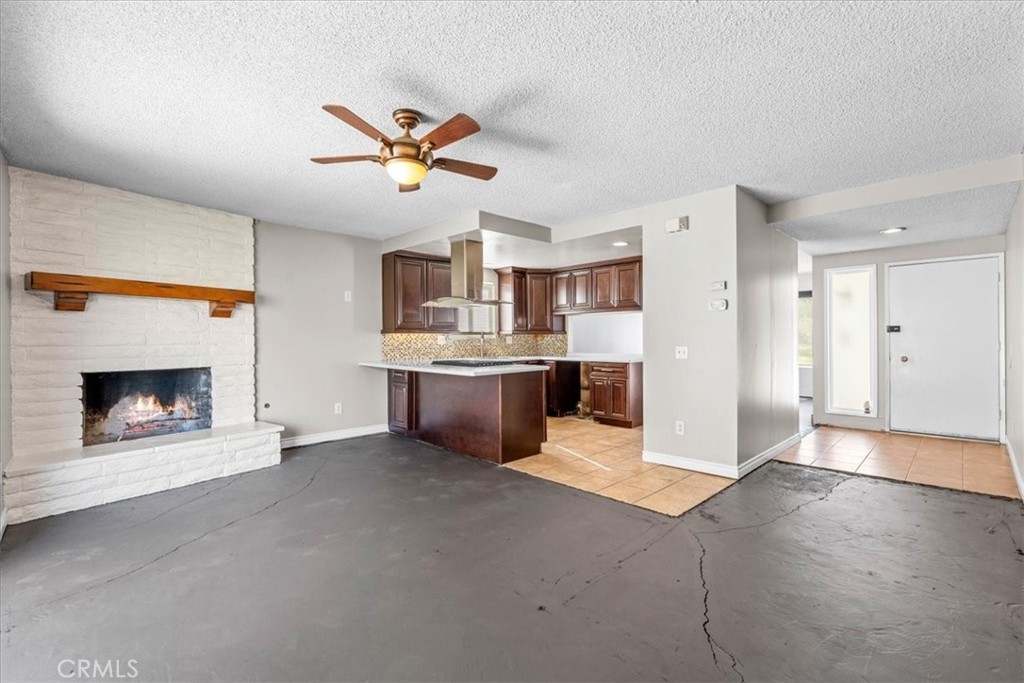 6240 Wiehe Avenue Riverside, CA 92506 - Photo 14 of 47 a view of a kitchen with a sink a fireplace and a window