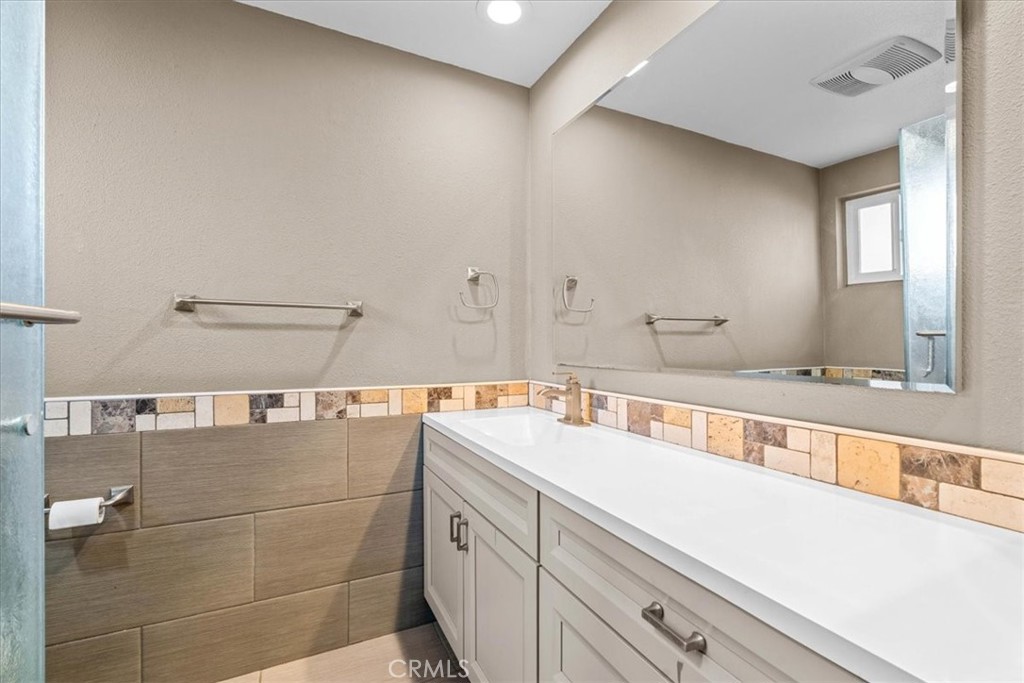 6240 Wiehe Avenue Riverside, CA 92506 - Photo 20 of 47 a bathroom with a double vanity sink and mirror